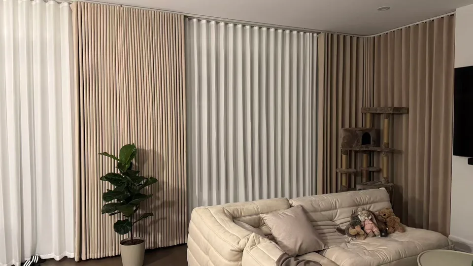 White sheers and neutral drapery wrapping a softly furnished living room